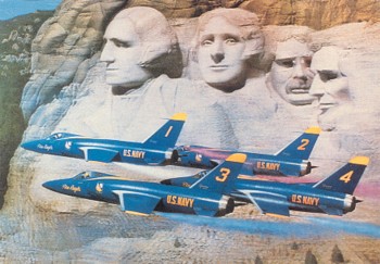 Featured is a postcard image of the US Blue Angels doing a "fly by" of Mount Rushmore ... the plane(s) pictured is the US Navy's first supersonic fighter, the "Tiger" - the Grumman F11f-1 - which served with the Blue Angels from 1957-67.  The Tiger was demoted from active duty due to its lack of range.  The original unused postcard is for sale in The unltd.com Store.